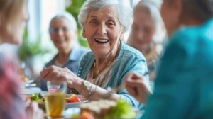 Staff guide older residents through a well-lit assisted living hallway during an emergency drill.